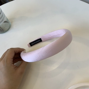 Pink handmade padded headband with elegant pearlescent texture for women