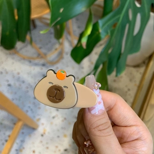 Cute Capybara hair clip with orange detail made of glossy acrylic for women's daily styling