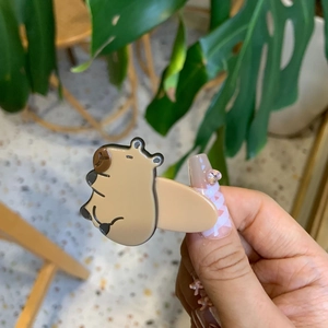 Cute Capybara hair clip held in hand featuring a creative animal cartoon design