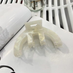 Detail of cream marble acetate hair claw with gold France Handmade engraved text