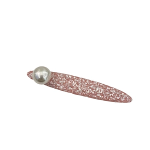 Pink resin hair clip with shimmering shell texture and a large grey faux pearl decoration