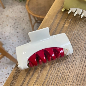 Elegant large color-blocking hair claw clip in beige and deep red with a glossy resin finish