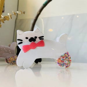Cute white cat hair claw clip with pink bow and colorful sprinkle details for women