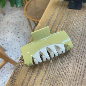 Minimalist light green and beige square hair claw clip for long hair on wooden table