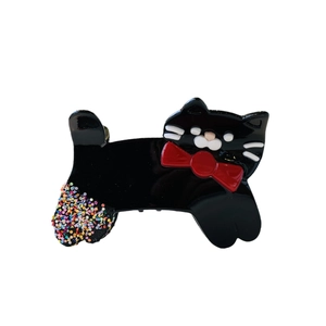 Cute black cat acetate hair claw clip with red bow and glitter tail on white background