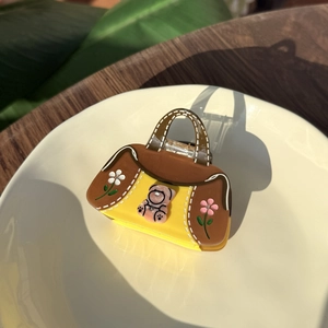 Cute acetate handbag-shaped hair claw clip with a pink bear and flower design