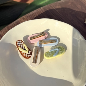 Close-up of five colorful acetate flip-flop hair clips with metallic duckbill clamps