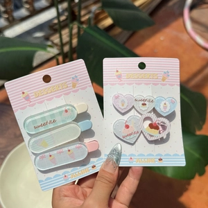 Macro detail of sweet ice dessert themed hair clips with pastel colors and heart shapes