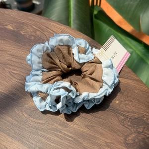 Polka dot bow scrunchie with sea salt blue ruffles and brown pleated inner fabric