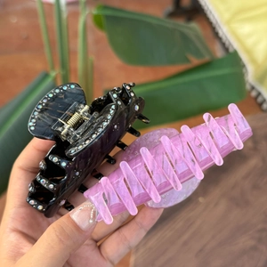 Macro view of acetate hair claw clips with sparkling rhinestones and glitter finish