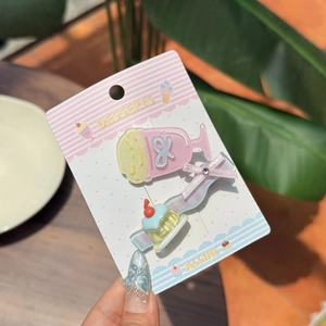 Detail of pink cold drink and yellow cake hair clips in a 2-piece dessert theme set