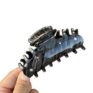 Acetate hair claw clip with black marble texture and sparkling rhinestones for women