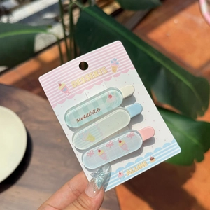 Close-up of sweet dessert themed hair clips with ice cream and cupcake patterns