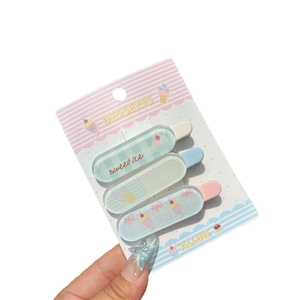 Three-piece macaron dessert hair clip set with ice cream shapes on striped display card