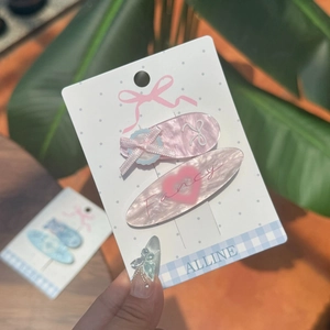 Set de barrettes à cheveux rose avec nœud et motif de cœur sur carte support