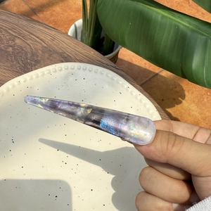 Translucent purple starry stiletto press-on nails with blue and gold glitter accents