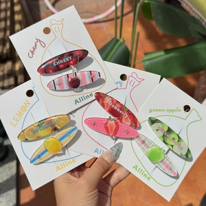 Close-up of acrylic fruit hair clips set featuring cherry and lemon slice patterns