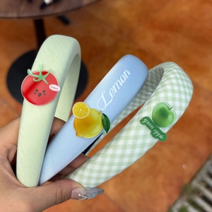 Detail of padded sponge headbands with cute lemon and tomato acrylic fruit patches