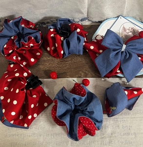 Detailed view of red polka dot and denim blue hair accessories with cherry and pearl accents