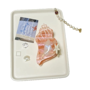Conch hair claw clip with marble texture and starfish detail for summer styles