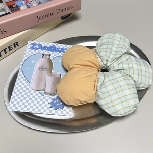 Floral fabric scrunchie with yellow and blue plaid patchwork design on a metal tray