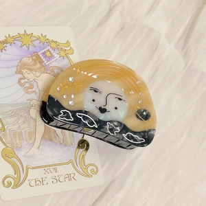 Dreamy sun and moon acetate hair claw clip with star patterns and sparkling rhinestones