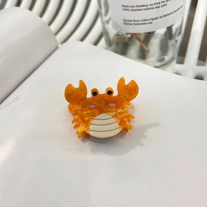 Pince à cheveux crabe orange en acétate marbré pour des coiffures stylées et mignonnes