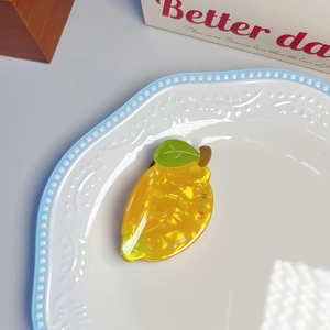Chic yellow lemon fruit hair claw clip made of pearlized acetate with leaf detail