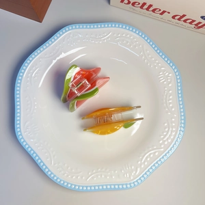 Detailed view of summer fruit hair claws featuring lemon and watermelon designs on a ceramic plate