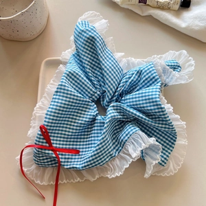 Blue and white plaid scrunchie with lace edges and a red ribbon bow accessory