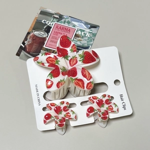 Three-piece set of white strawberry hair clips featuring a large claw and two mini clips
