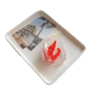 Cute transparent red shrimp hair claw clip on a beach postcard background for women