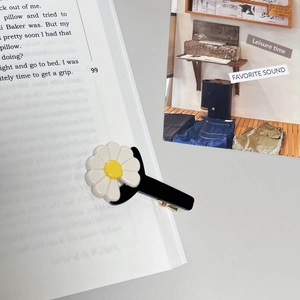 Sweet daisy hair clip with white petals and yellow core on a black duckbill clip