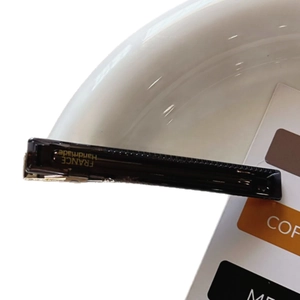 Elegant long acetate hair clip with gold label handmade in France on white ceramic plate