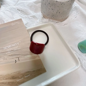 Elegant French vintage wine red hair tie with handmade square charm on a ceramic tray