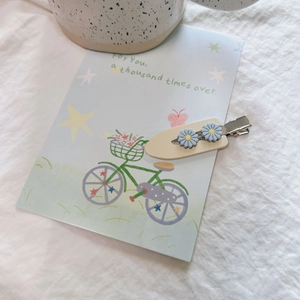 Daisy hair clip with blue flowers and beige base in a soft aesthetic scene