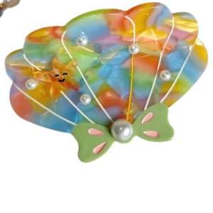Cute acetate seashell hair claw clip with starfish and pearl accents in colorful gradient