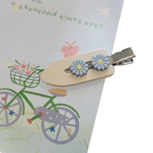 Charming acetate daisy hair clip with cream base and blue flowers for girls