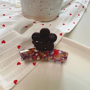 Floral acetate hair claw clip with colorful marble pattern and purple flower design