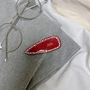 French style red teardrop hair clip with gold text and sparkling rhinestone edge
