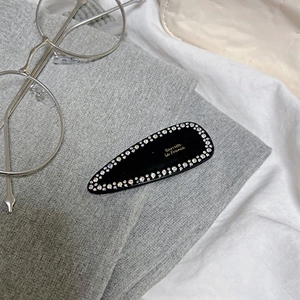 French style black teardrop hair clip with sparkling rhinestones and golden logo