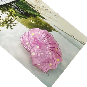 Pink shell hair claw clip with star and bow patterns for ocean style beach hair styling