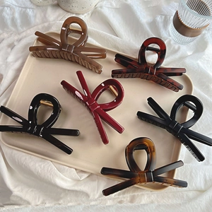 Set of six elegant 13.5cm bow-shaped hair claws in assorted solid colors and tortoise patterns
