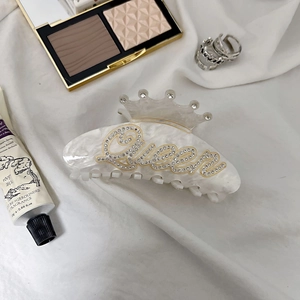 Elegant white marble acrylic hair claw with crown design and Queen rhinestone lettering