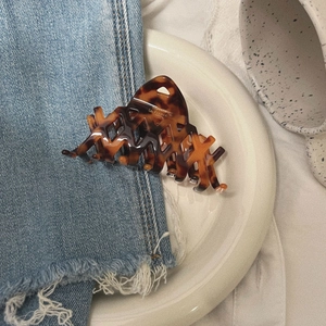 French style tortoise shell shark hair claw clip on denim fabric and ceramic plate