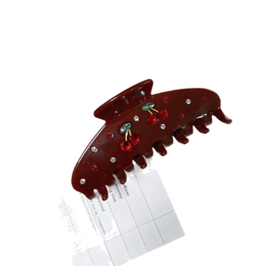 Vintage caramel acetate hair claw clip with cherry rhinestone design and sparkling finish