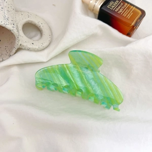 Sparkling green and yellow marble hair claw clip for thick hair with a glossy stripe finish