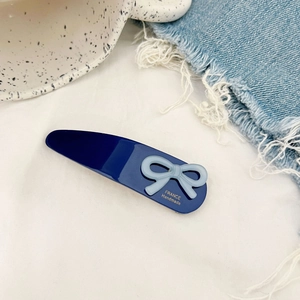 French style navy blue rectangular hair clip with light blue bow and gold lettering