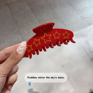 Elegant large red hair claw clip with golden rhinestone star patterns for women