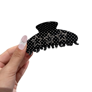 Chic black polka dot hair claw clip with rhinestone star accents for women hair styling